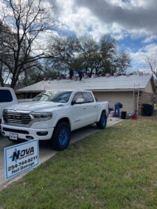 Nova Roofing Truck in front of house getting a replacement roof